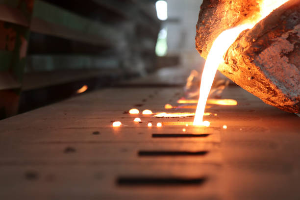 Iron molten metal pouring in sand mold Iron molten metal pouring in sand mold ; green sand process melting metal stock pictures, royalty-free photos & images