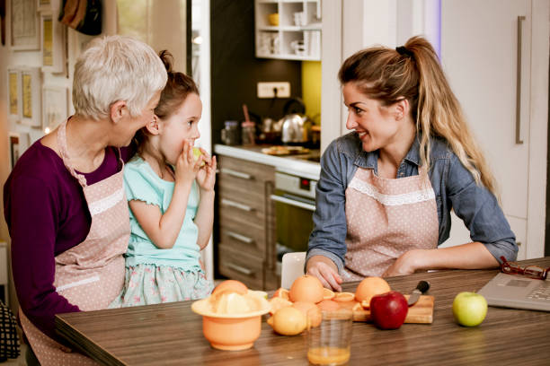 istock Family cooking together in cozy comfortable kitchen 1057053062
