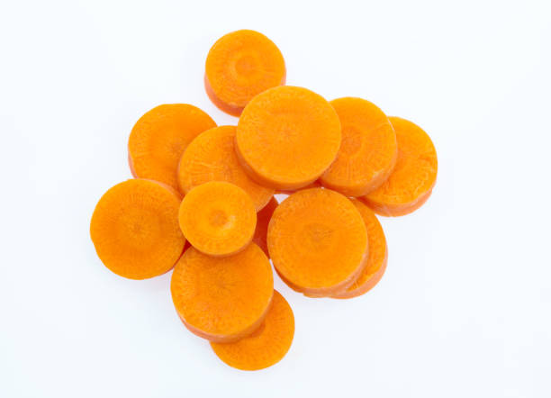 морковные ломтики на белом фоне - carrot isolated white carotene стоковые фото и изображения