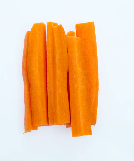 karotten-sticks auf weißem hintergrund - carrot isolated white carotene stock-fotos und bilder