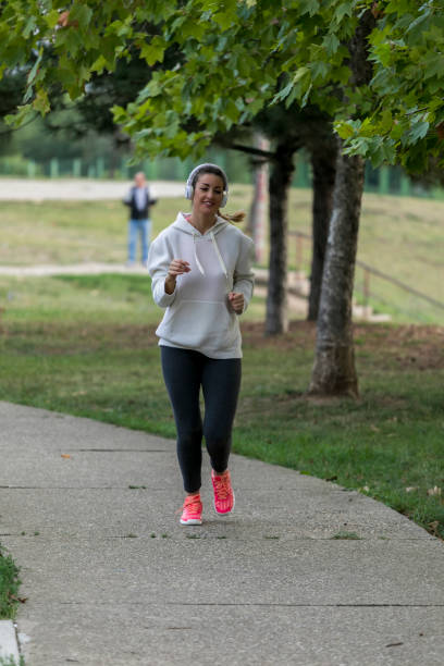 istock Woman Training in park with music 1057059222
