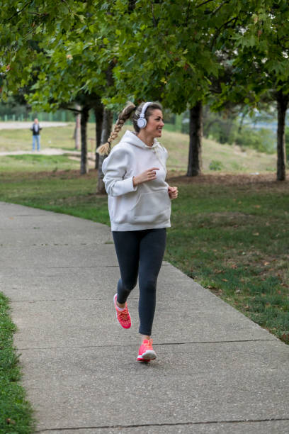 istock Woman Training in park with music 1057059296