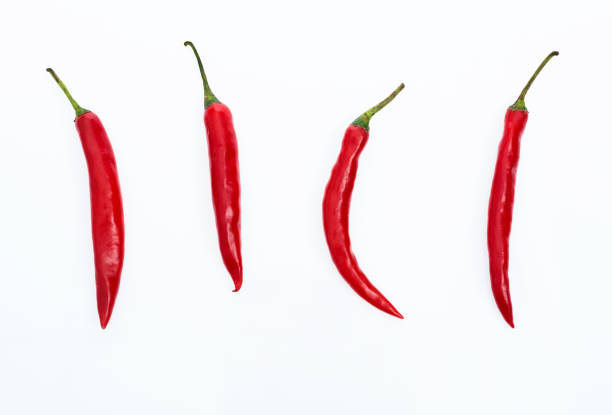 istock Red chili peppers on white background 1057059306