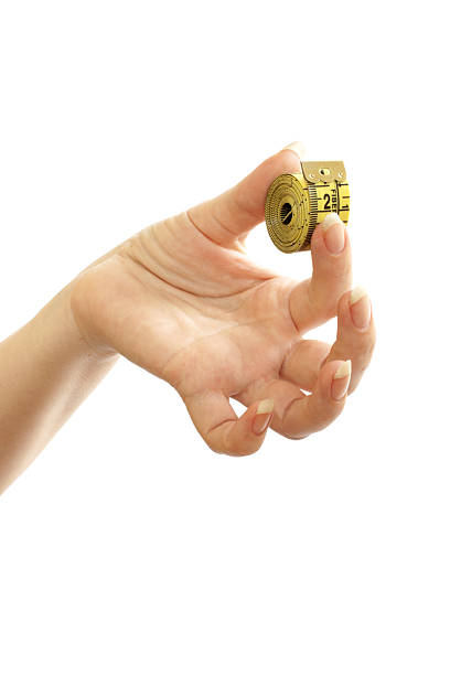 istock tape measure in a beautiful female hand 105705970