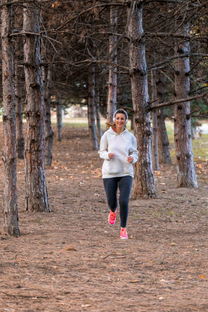 istock Woman Training in park with music 1057060804