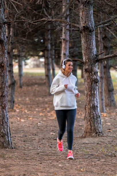 istock Woman Training in park with music 1057060958