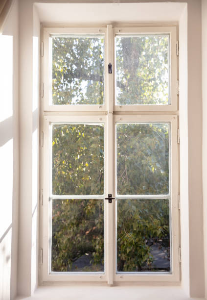 istock White old fashioned wooden window on white wall 1057061360