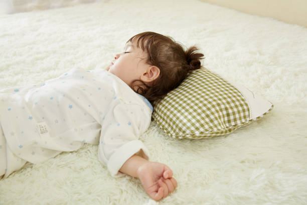 istock Cute little girl sleeping in bed 1057062930
