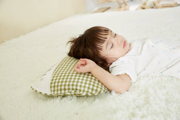 istock Cute little girl sleeping in bed 1057062950