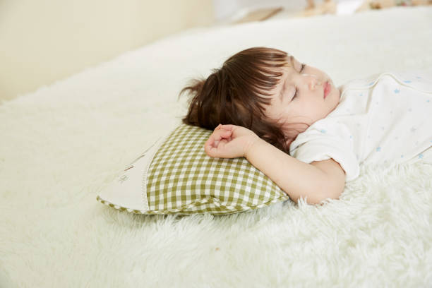 istock Cute little girl sleeping in bed 1057062966