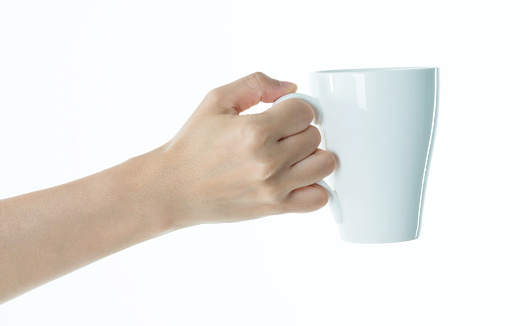 Woman hand holding a white mug on white background.