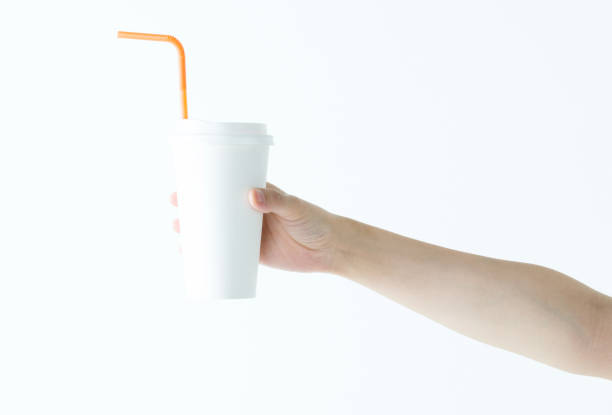 istock Woman hand holding a white disposable cup 1057066514