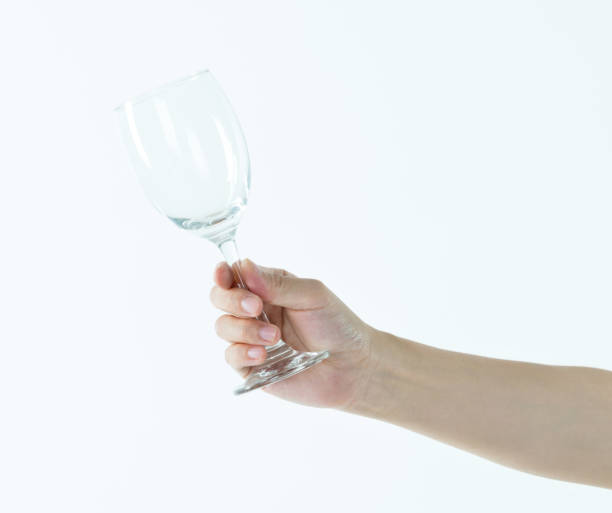 istock Woman hand holding empty wine glass 1057066568