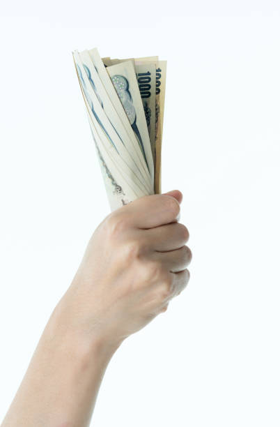 Woman hand holding Japanese yen notes.