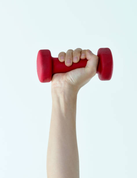 istock Woman hand holding a dumbbell on white background 1057066978