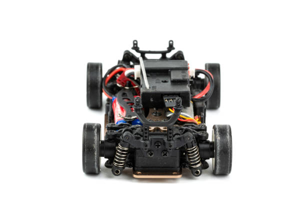 istock Back view of RC drift car (Radio-controlled) without body isolated on white background. (This toy has some dust from children playing) 1057067432