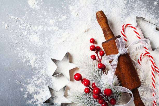 istock Bakery background for cooking christmas baking with rolling pin and scattered flour decorated with fir tree. 1057067928