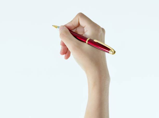 istock Woman hand holding a pen on white background 1057069396