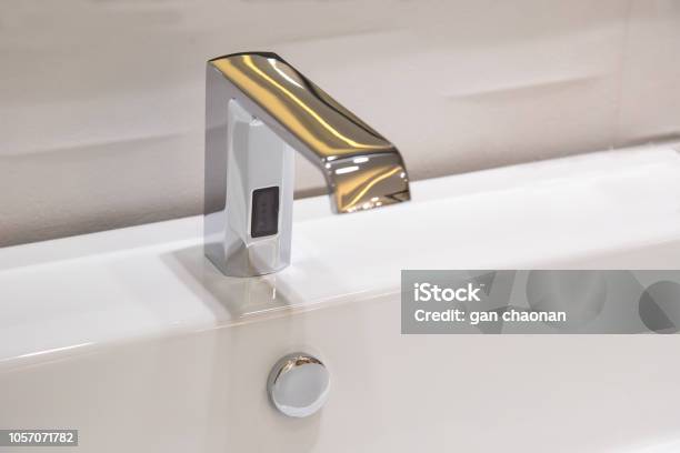 Bathroom Faucet In Polished Chrome Powered Automatic By Sensor Object About Home Improvement Stock Photo - Download Image Now