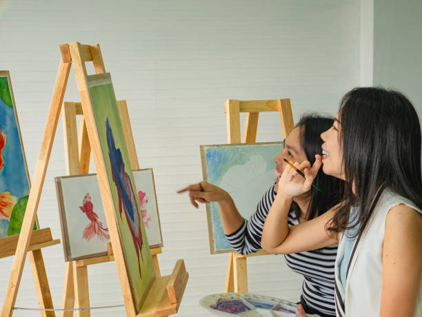 istock Two young asian woman artist dawning while useing ideas to think and create the best artwork together 1057071966