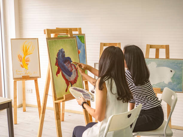 istock Two young asian woman artist dawning while useing ideas to think and create the best artwork together 1057072094