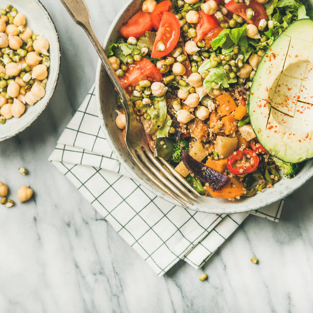 istock Vegan dinner bowl with avocado, grains, beans, vegetables, square crop 1057075988