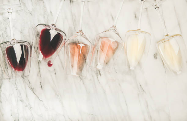 istock Red, rose, white wine in glasses and corkscrews, copy space 1057076046