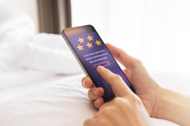 istock Customer Experience Concept. Happy Client Using Smartphone on Bed to Writing Positive Review and Sending Feedback Online 1057076500
