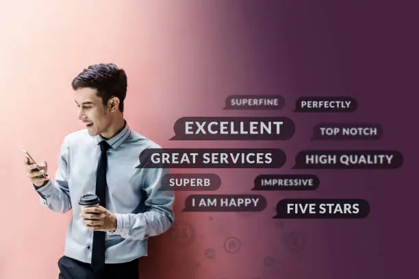 Photo of Customer Experience Concept. Happy Businessman using Smart Phone to Reading Positive Review or Feedback his Satisfaction Online Survey, Surrounded by Speech Bubble and Social Network icons