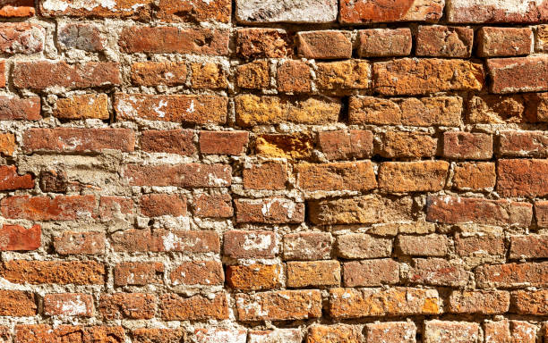 istock Background of old weathered red brick wall 1057076598