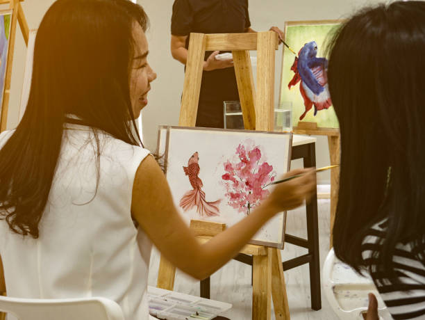 istock Two young asian woman artist dawning while useing ideas to think and create the best artwork together 1057081560
