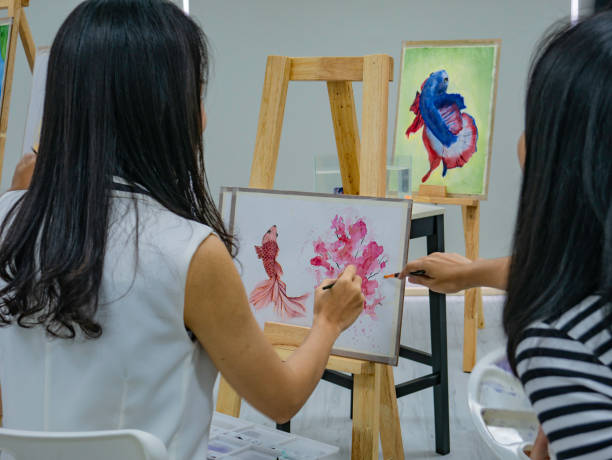 istock Two young asian woman artist dawning while useing ideas to think and create the best artwork together 1057082056