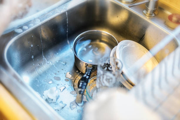 istock Hand Washed Dishes in a Stainless Steel Sink 1057082322