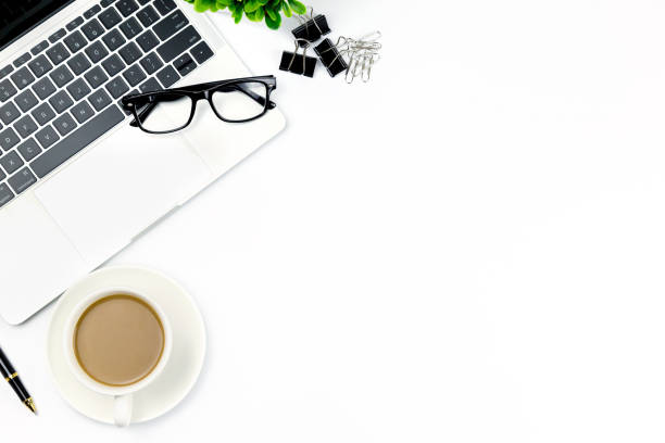 istock Workspace in office ,White desk with blank notebook and other office supplies,Top view with copy space. 1057085276