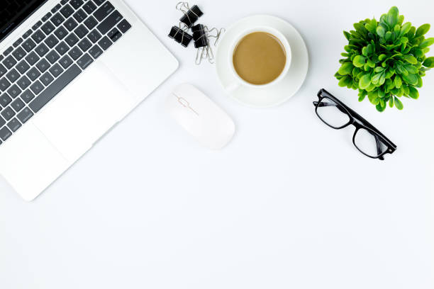 istock Workspace in office ,White desk with blank notebook and other office supplies,Top view with copy space. 1057085340