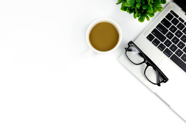 istock Workspace in office ,White desk with blank notebook and other office supplies,Top view with copy space. 1057085414