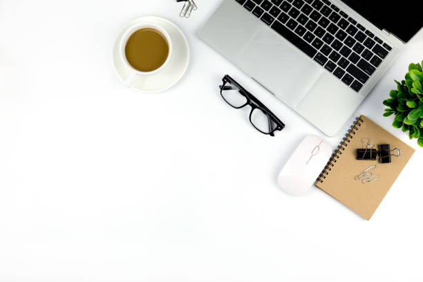 istock Workspace in office ,White desk with blank notebook and other office supplies,Top view with copy space. 1057085438