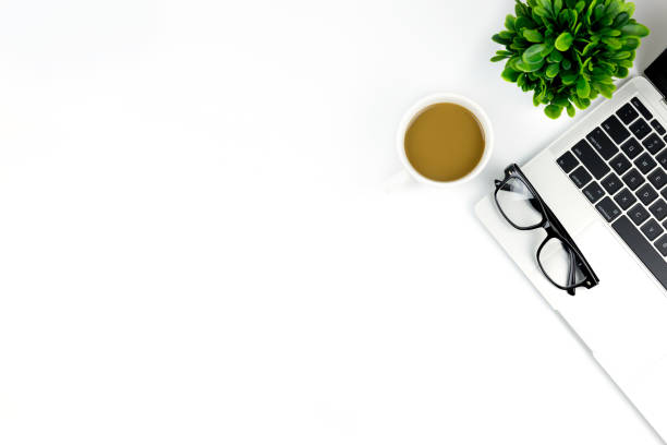 istock Workspace in office ,White desk with blank notebook and other office supplies,Top view with copy space. 1057085484