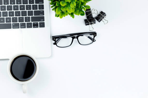 istock Workspace in office ,White desk with blank notebook and other office supplies,Top view with copy space. 1057085606