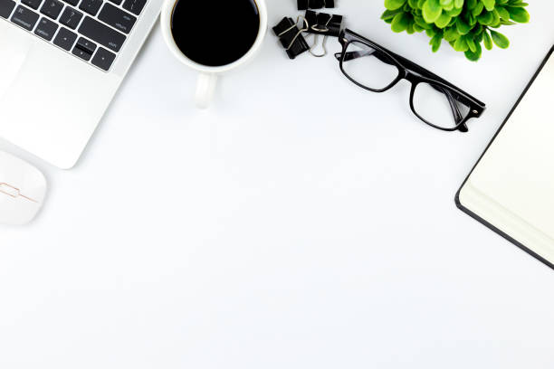 istock Workspace in office ,White desk with blank notebook and other office supplies,Top view with copy space. 1057085732