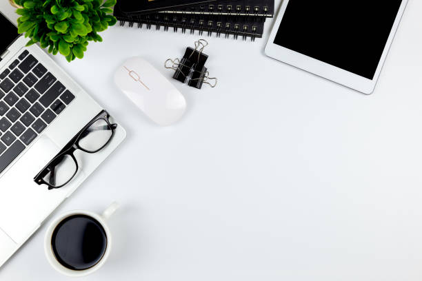 istock Top view of Office desk with workspace in office with blank notebook tablet and smartphone with other office supplies,with copy space. 1057087852