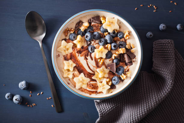 istock healthy banana smoothie bowl with blueberry chocolate walnuts 1057090836