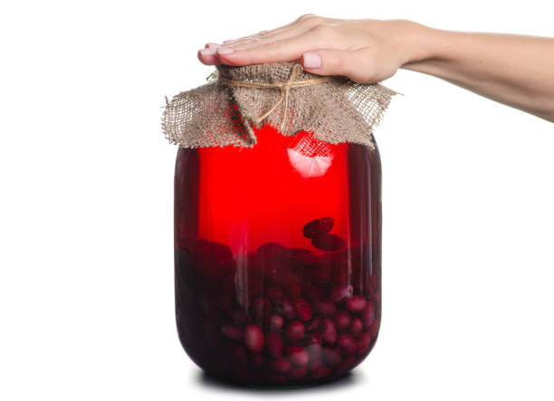 istock Compote grapes jar female hand 1057095738