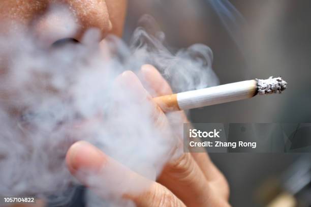 Smoking A Cigarette Stock Photo - Download Image Now - Smoking Issues, Smoking - Activity, Cigarette