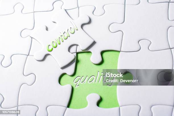The Words Quality And Control In Missing Piece Jigsaw Puzzle Stock Photo - Download Image Now