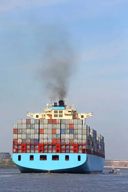 blue containership on elbe