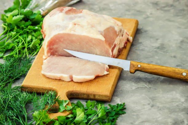 istock piece of pig meat on the Board. Cooking. Selective focus. 1057108808