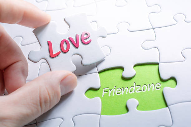 the words love and friendzone in missing piece jigsaw puzzle - bff imagens e fotografias de stock