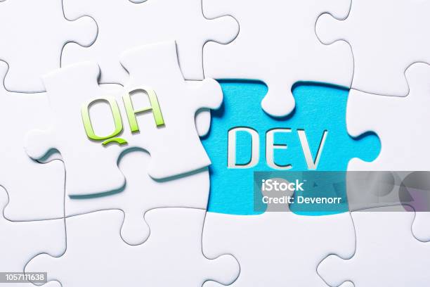 The Words Qa And Dev In Missing Piece Jigsaw Puzzle Stock Photo - Download Image Now