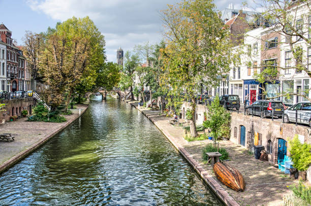 Utrecht, The Netherlands, September 1, 2018: View of the double quays of the Oude Gracht (Old Canal), with cars and other traffic on the upper quay and leisure activities on the lower level